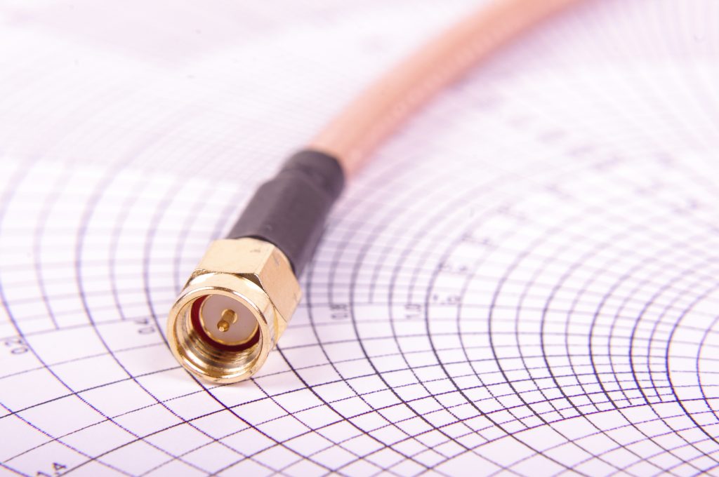 Macro close up of radio frequency cable with SMA connector on the Smith chart